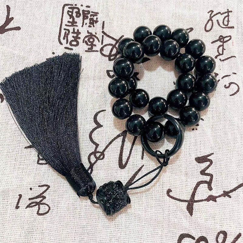 Holding prayer beads, tassel charms, bracelets for men and women