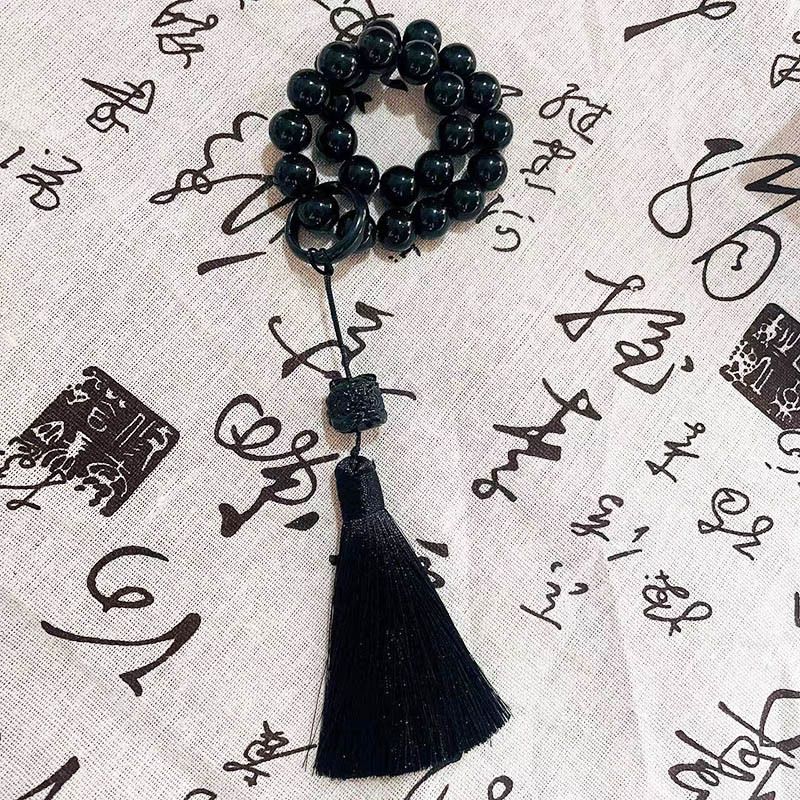 Holding prayer beads, tassel charms, bracelets for men and women