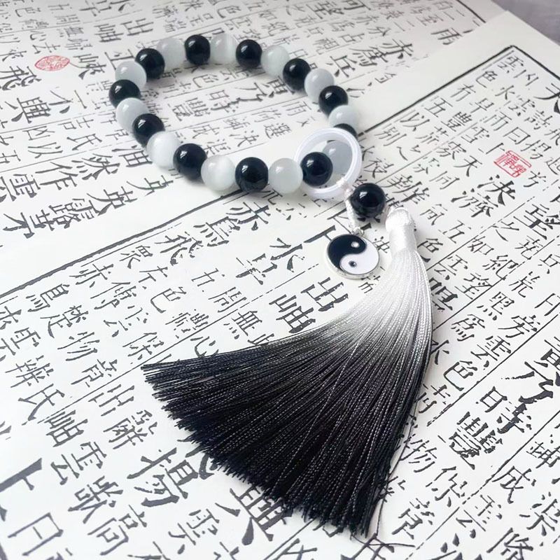 Holding prayer beads, tassel charms, bracelets for men and women