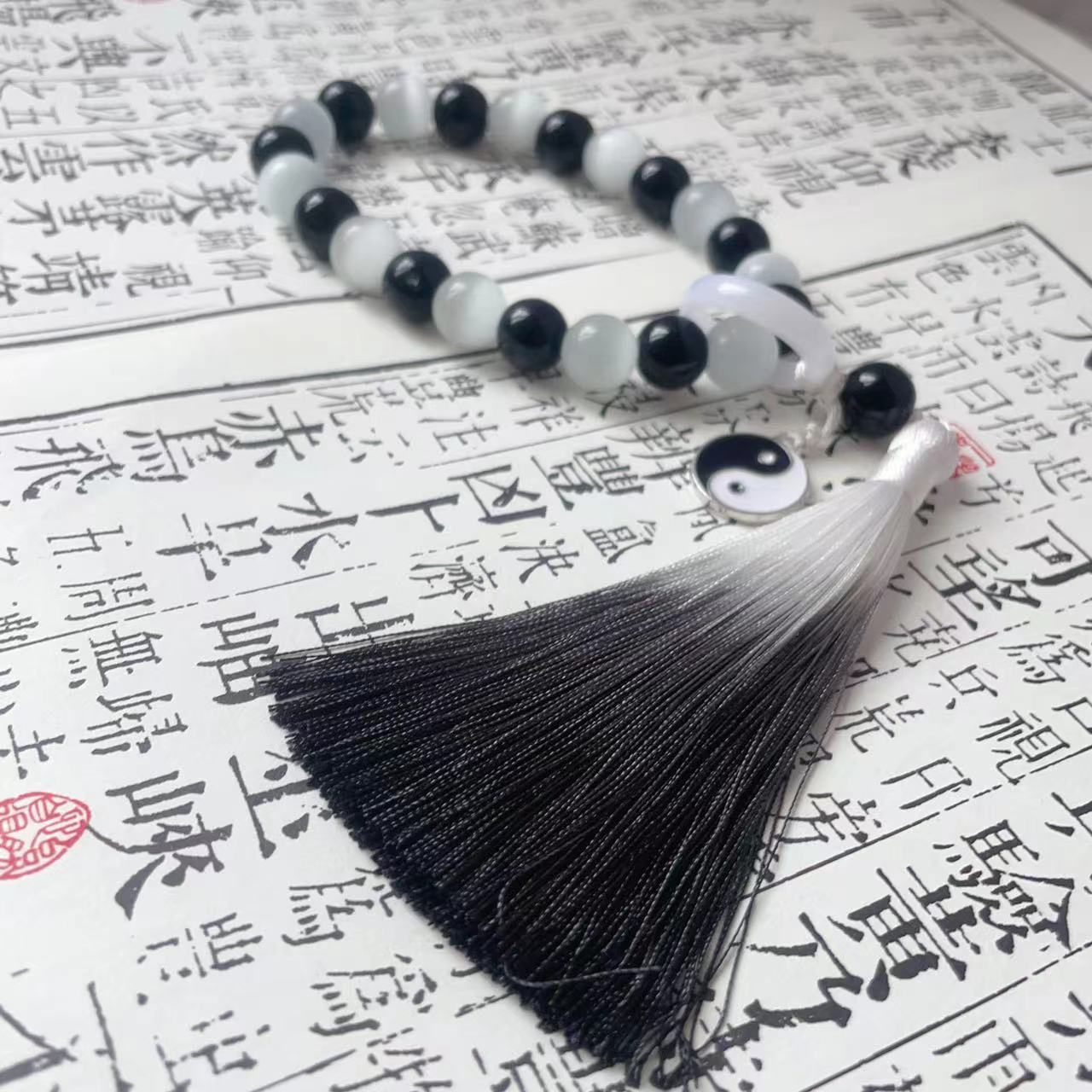 Holding prayer beads, tassel charms, bracelets for men and women