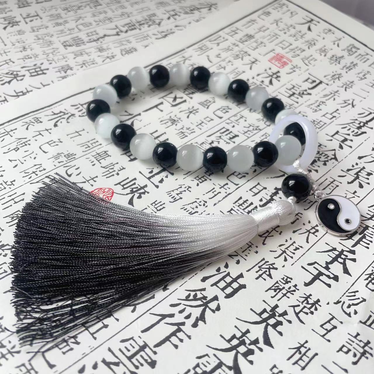 Holding prayer beads, tassel charms, bracelets for men and women