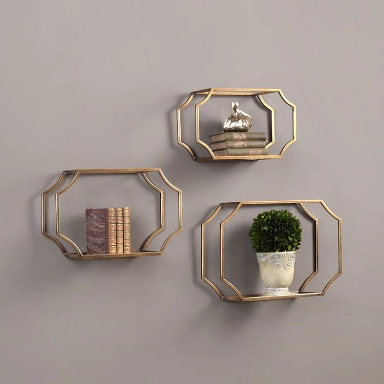 Classic Set of 3 Shelving Units In Gold Finished Iron With Curved Open-Framed Design and Clear Glass Bottom for Decorating Wall.