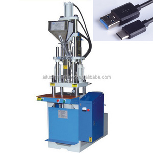 Small vertical injection machine for molding charger cable