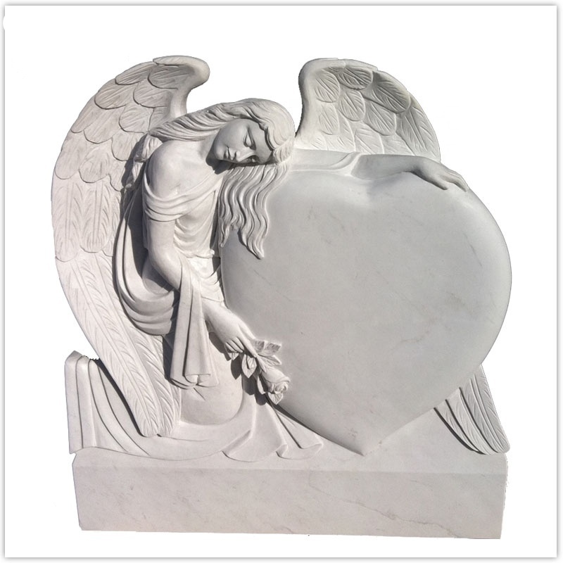 White marble gravestone with sculpture sad angel with head down