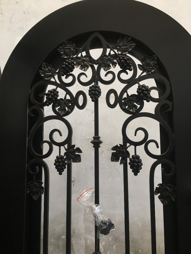 Decorative wrought iron single wine cellar entry doors