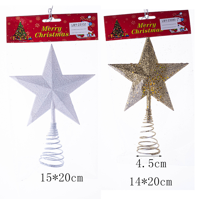 The new plastic Christmas star sparkles with gold and white stars on top of the tree decorations