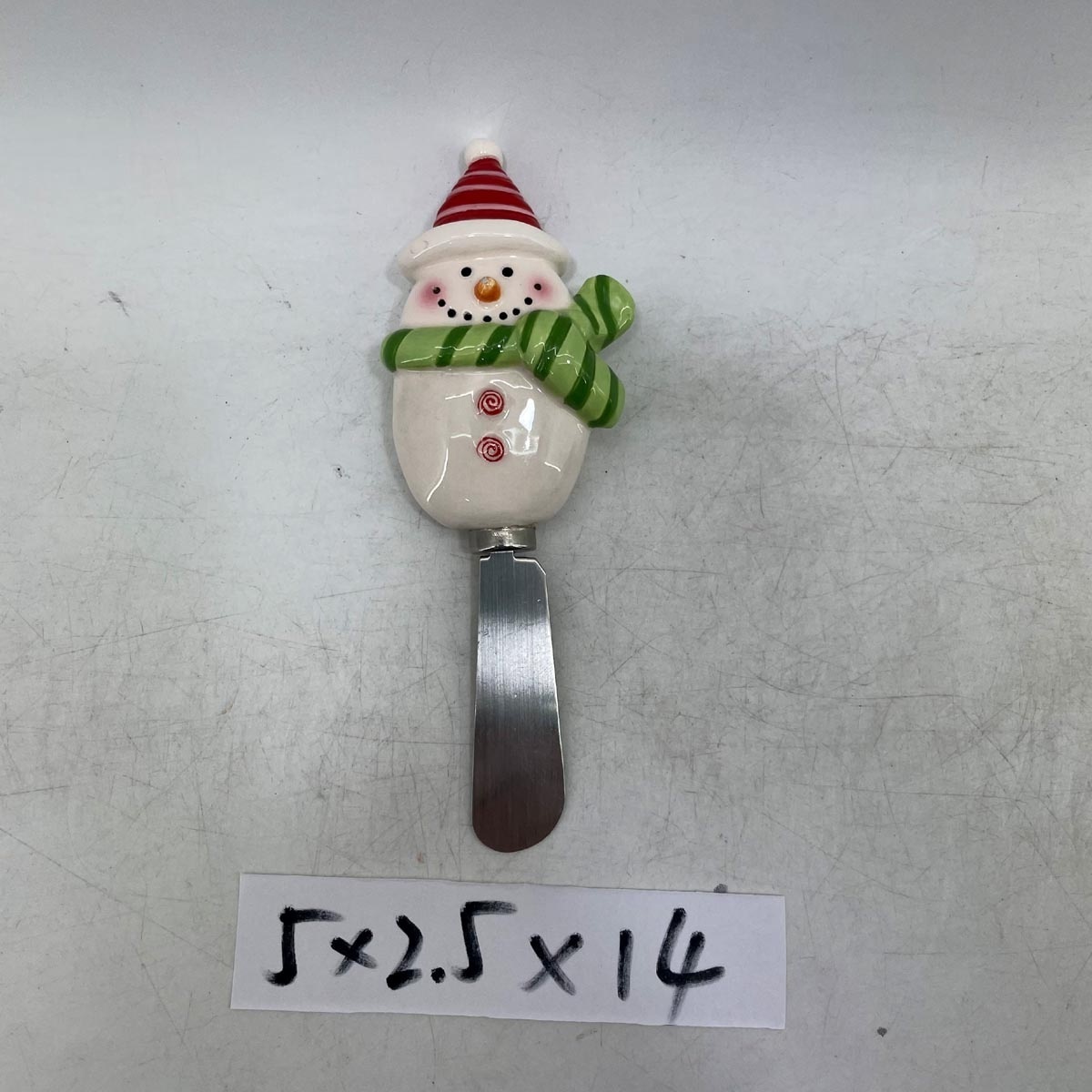 Stainless steel cheese spreader with ceramic santa handle