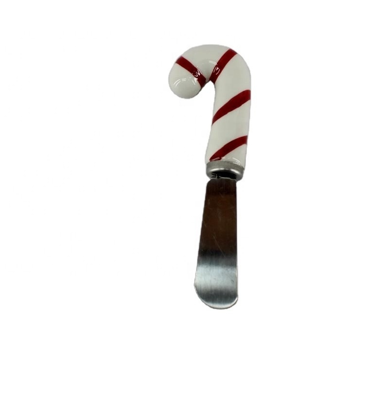 Cheese spreader with hand-painted ceramic gingerbread man handle