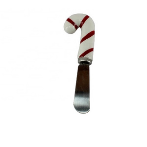 Cheese spreader with hand-painted ceramic gingerbread man handle