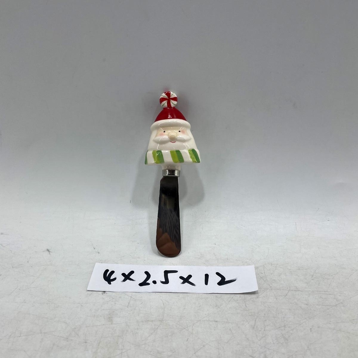 Stainless steel cheese spreader with ceramic santa handle