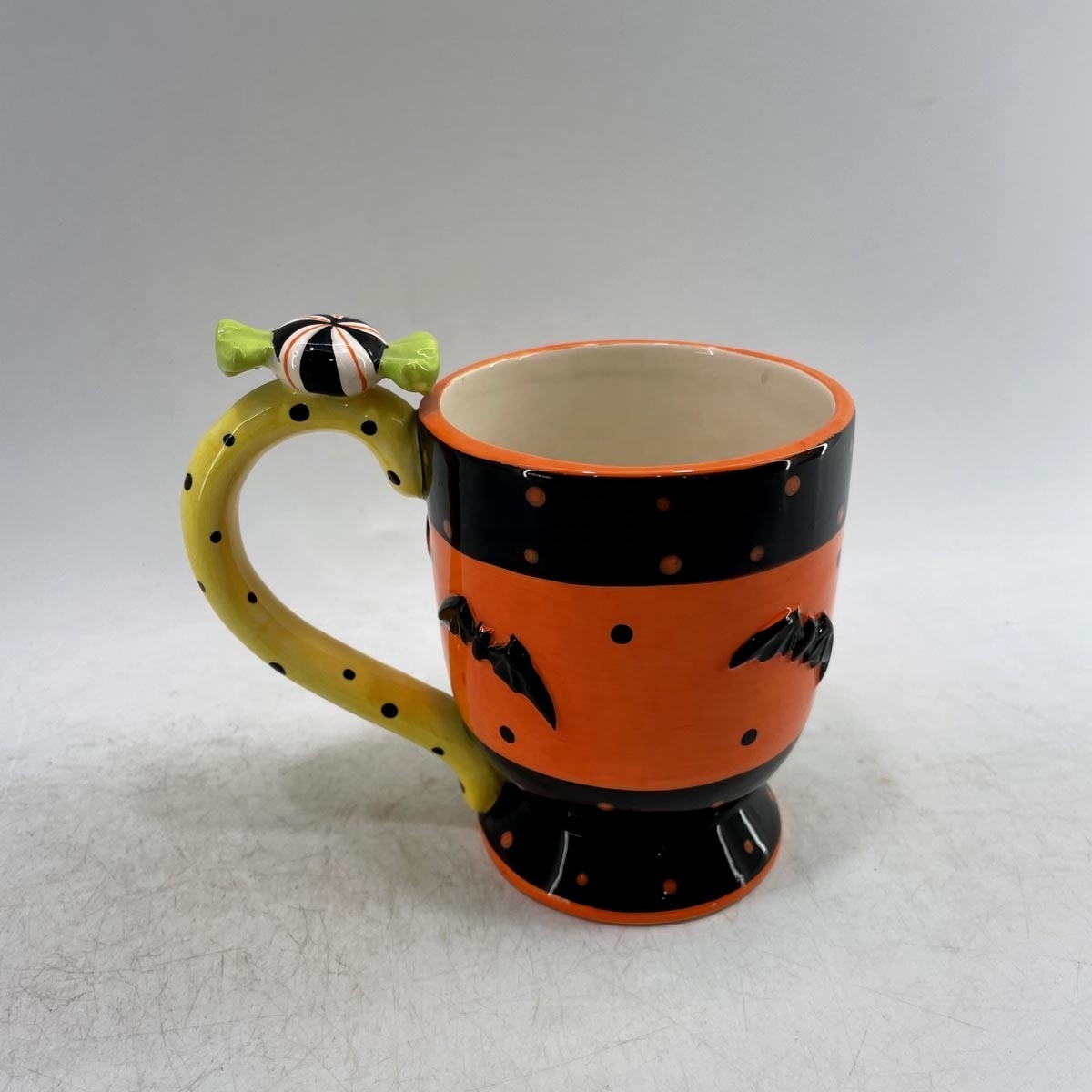 Candy shaped ceramic coffee mug with bat decoration