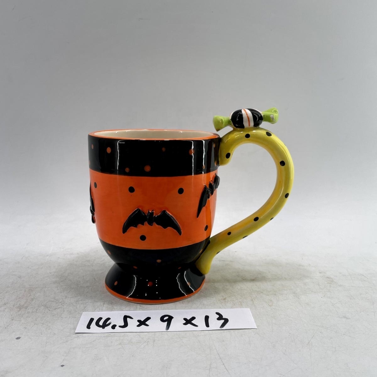 Candy shaped ceramic coffee mug with bat decoration