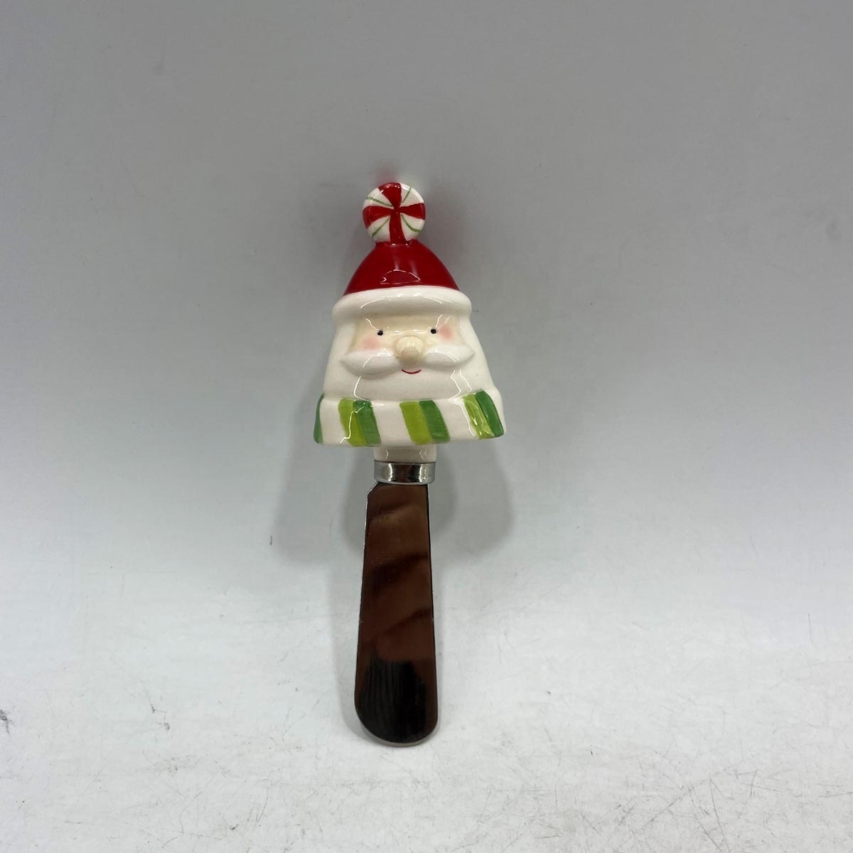 Stainless steel cheese spreader with ceramic santa handle