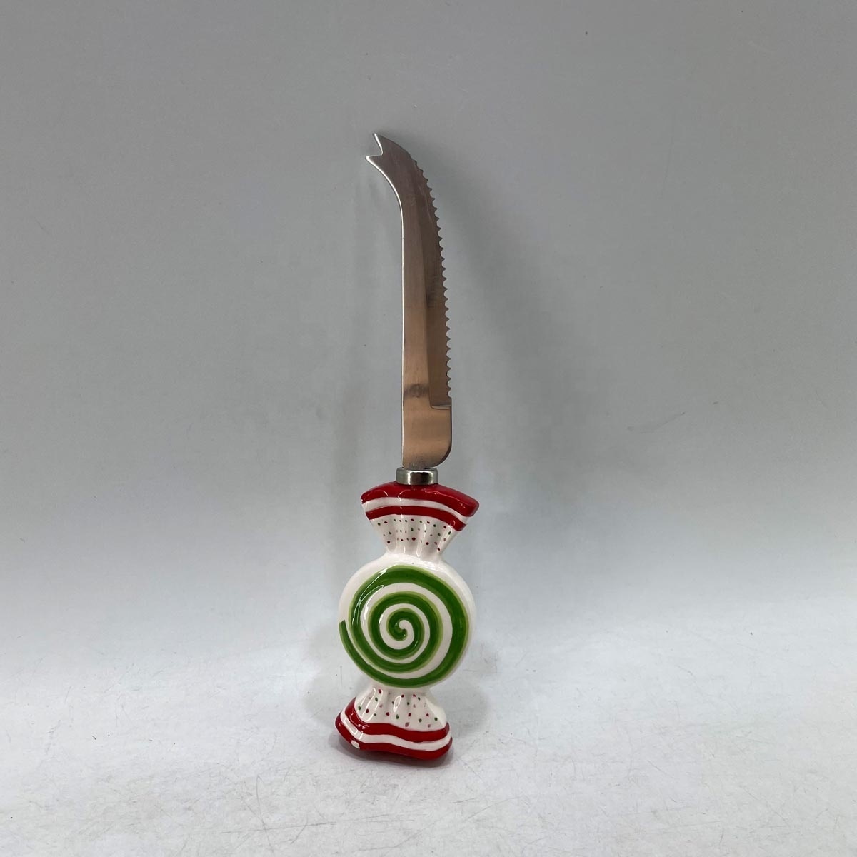 Stainless steel cheese spreader with handpainted ceramic snowman handle