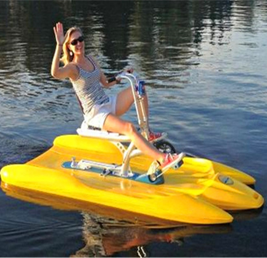 1 person lake sitting water cycling in water paddle bike