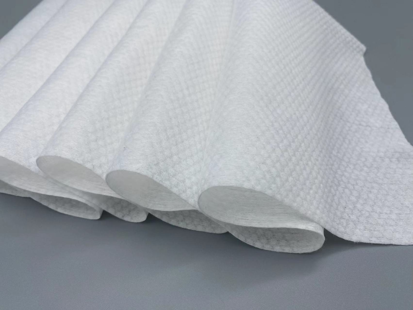 Custom adhesive mesh wet wipes non-woven spunlace cloth roll face towel raw material manufacturers spunlace non-woven fabric