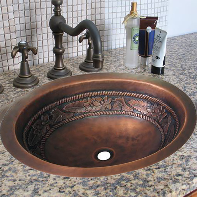 Hand hammered copper bathroom sink with oval shape design