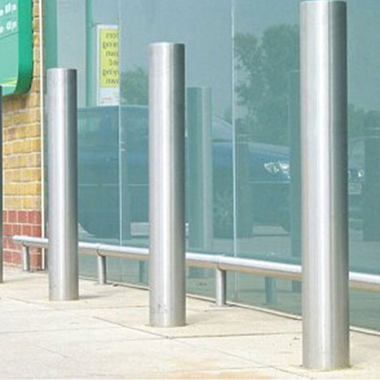 outdoor roadside metal fixed security bollard outside street roadway sidewalk driveway standing traffic barrier