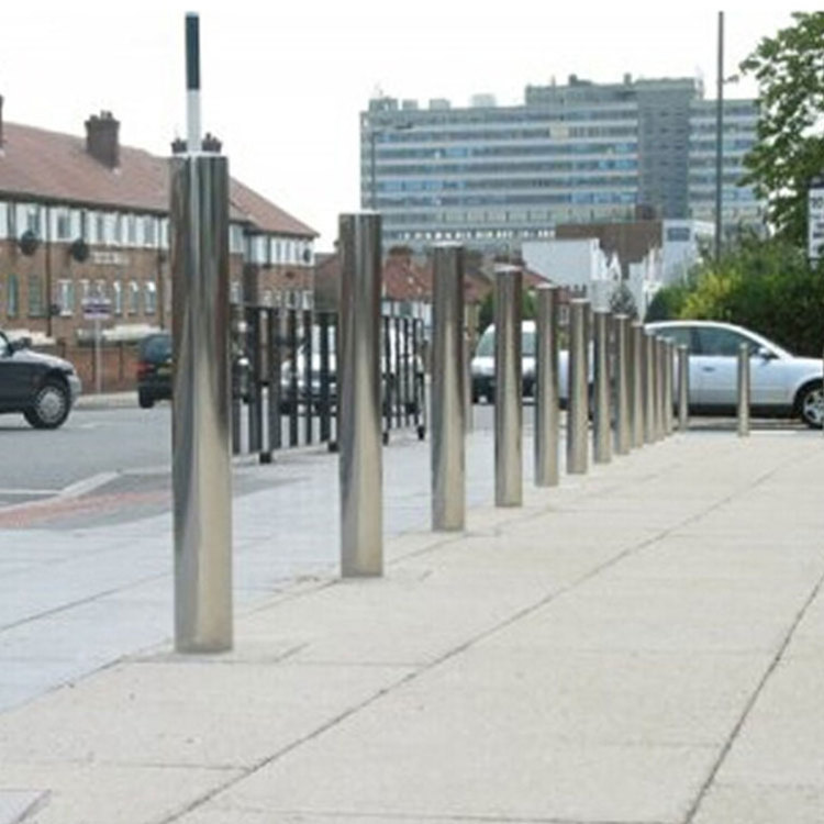 outdoor roadside metal fixed security bollard outside street roadway sidewalk driveway standing traffic barrier