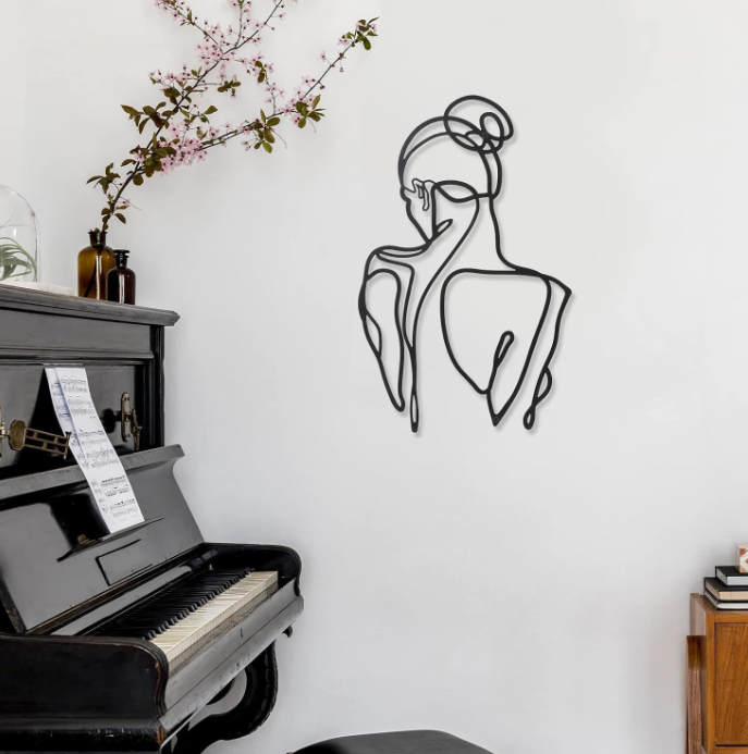 Customized laser cut metal mural with abstract and minimalist female body lines in art