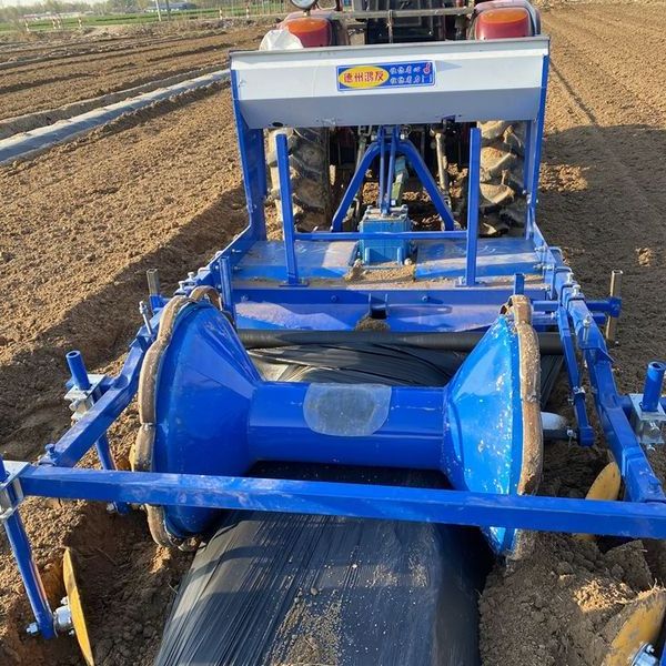 Small tractor mounted plastic mulch applicator laying ridger laminating machine