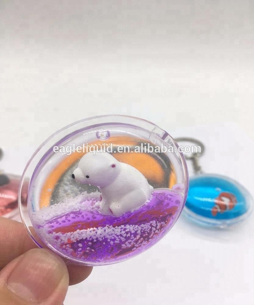 Hot sale 3D floating round keyring custom liquid  Keychain with crown fish cute keychain charms