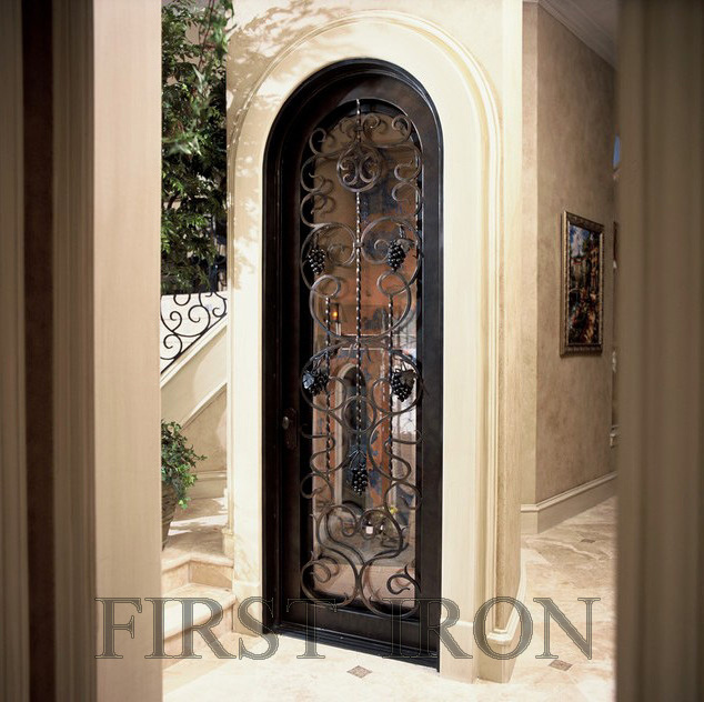 Decorative interior vine cellar door, single eyebrow forged iron door