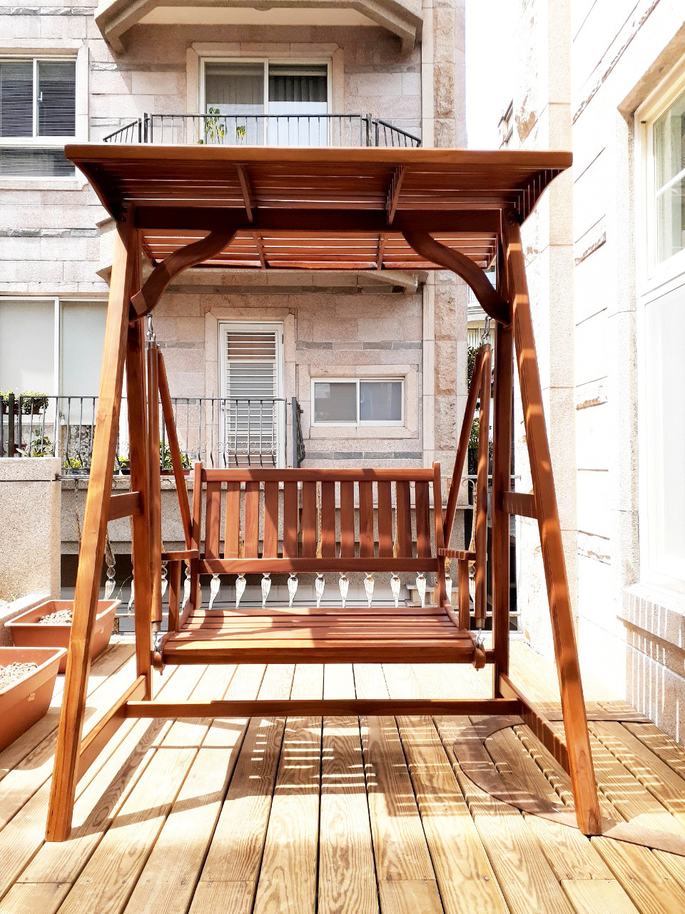 Enjoying Vacation Vibe with a Sunshielded Teak Outdoor Swing Chair for Your Patio, Balcony and Garden