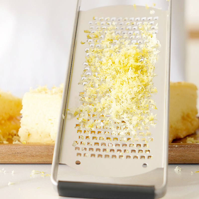 Durable stainless steel cheese grater with wooden handle  lemon zester