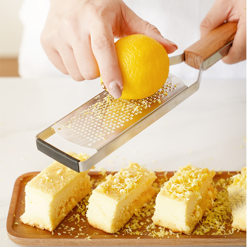 Durable stainless steel cheese grater with wooden handle  lemon zester