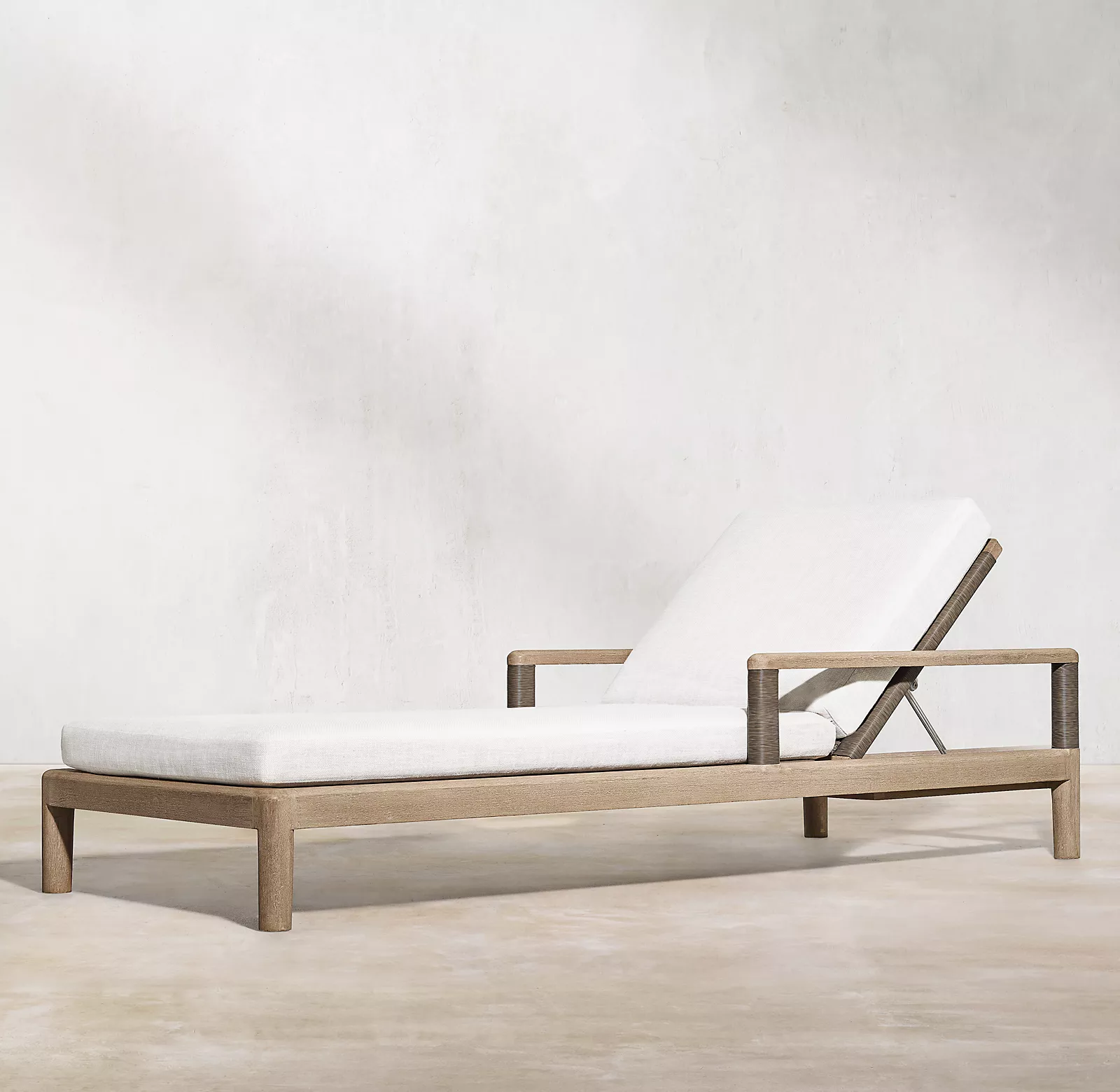 Handcrafted of solid teak and all-weather wicker outdoor chaise