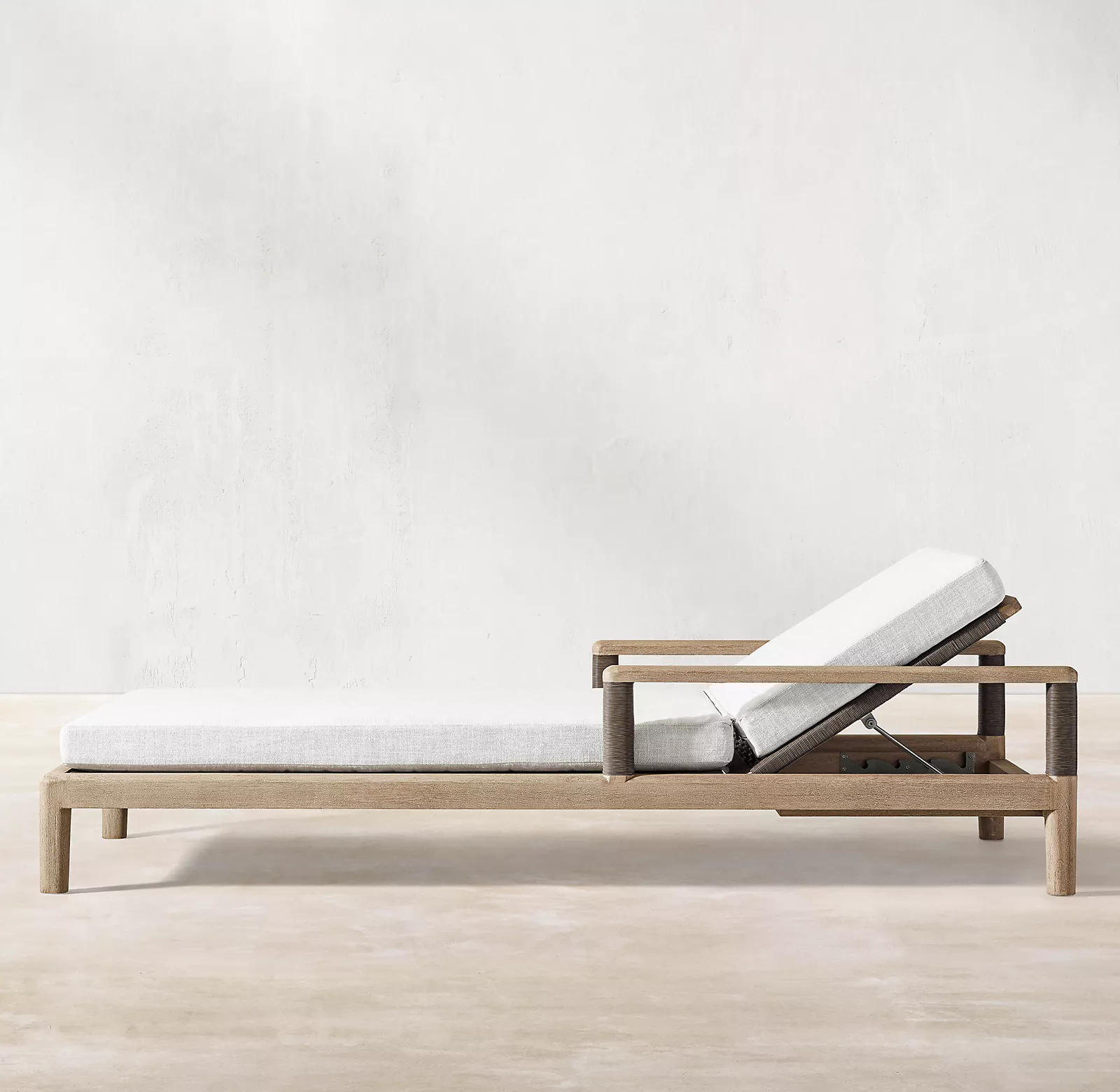 Handcrafted of solid teak and all-weather wicker outdoor chaise