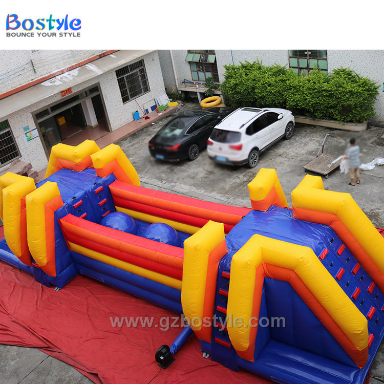 Inflatable Wipeout style bouncing balls obstacle course and drop slide for sale