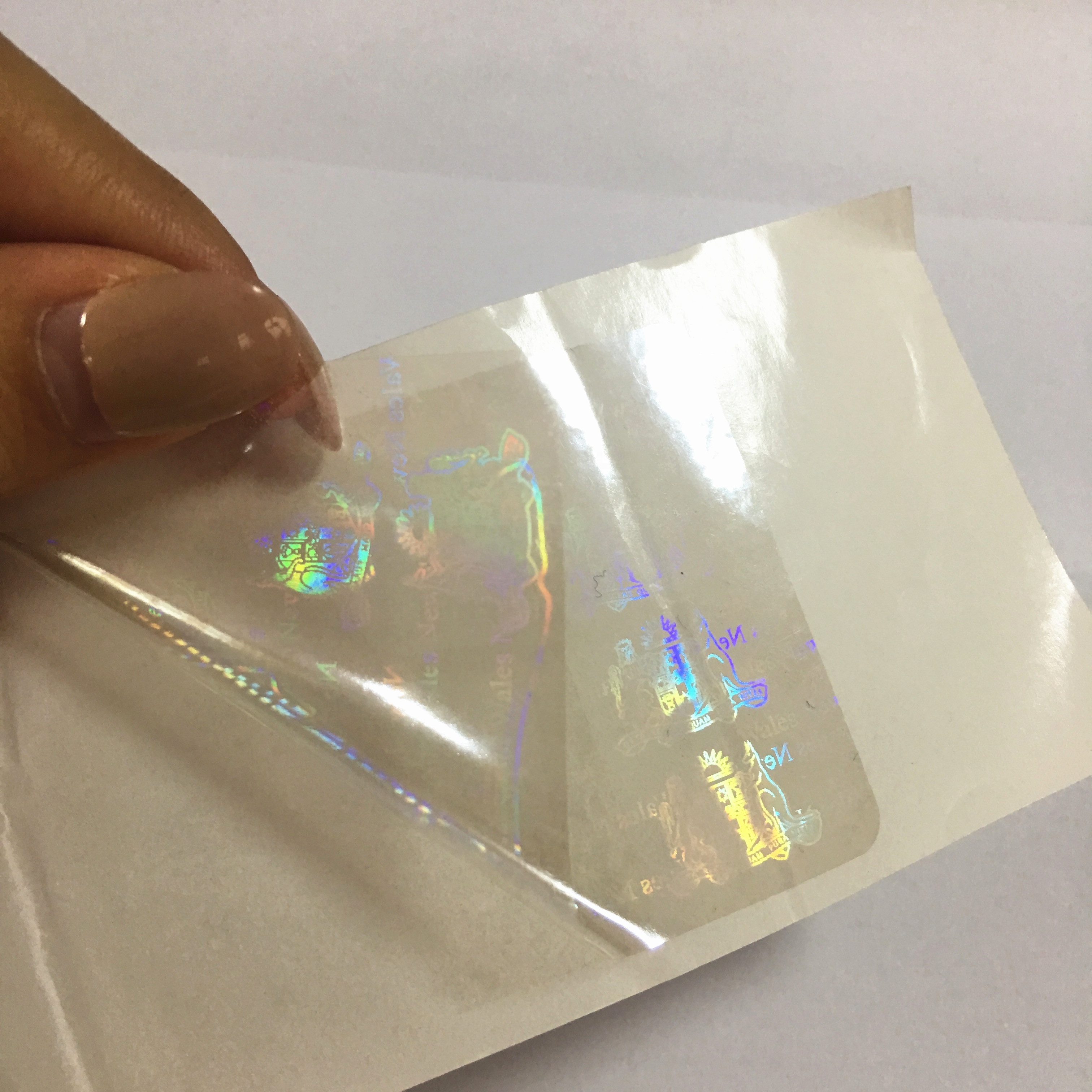 Anti-counterfeiting nsw transparent overlay hologram with custom logo