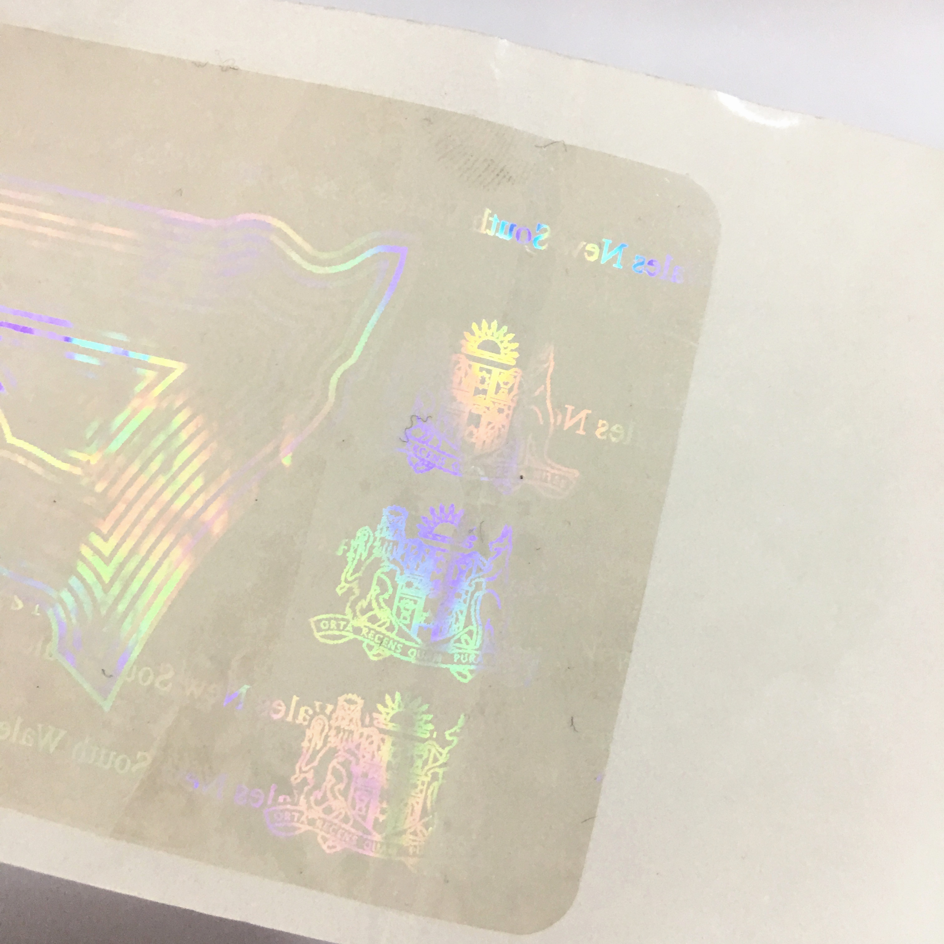 Anti-counterfeiting nsw transparent overlay hologram with custom logo