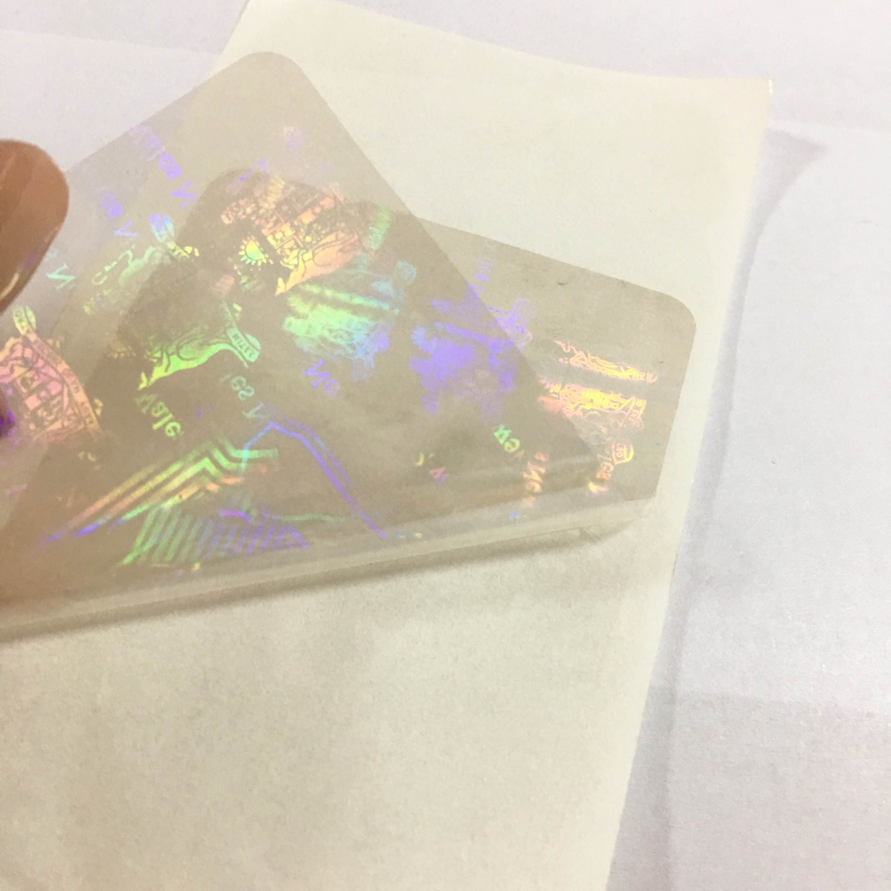 Anti-counterfeiting nsw transparent overlay hologram with custom logo