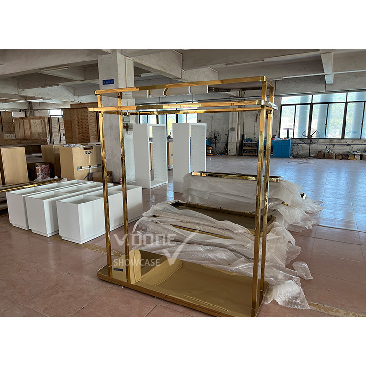 Modern Brand Famous Customized Hanging Garment Display Rack Golden Clothing Display Stand For Clothes Store Interior Design