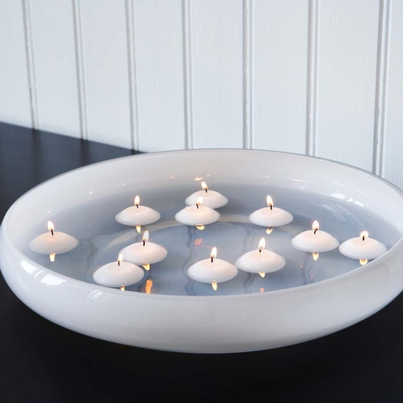 Paraffin wax unscented white floating candle on water