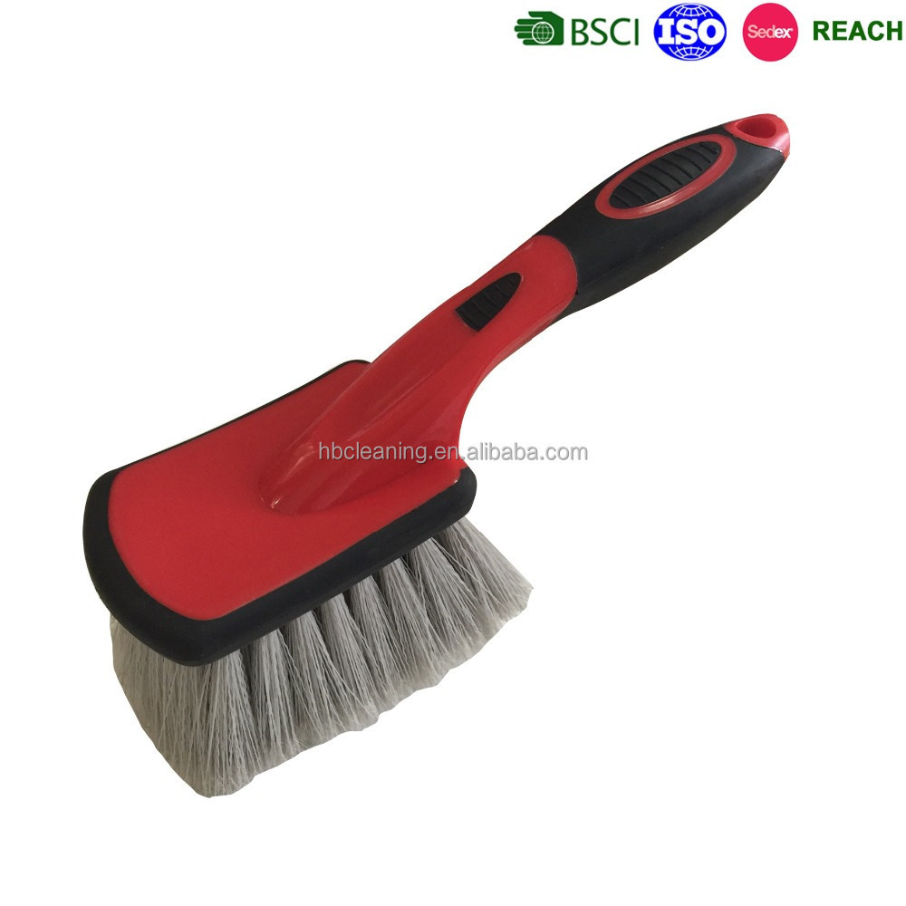 professional automatic car wheel cleaning brushes in hand