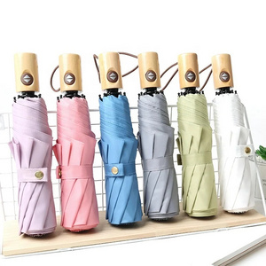 Solid color literary wholesale custom fully automatic 3 folding gift umbrella with wooden handle