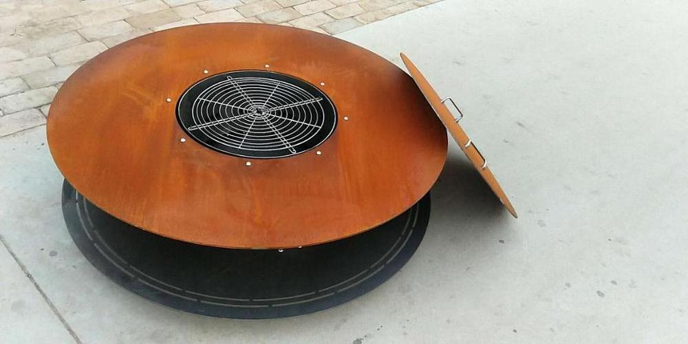 Assembled outdoor round fire pit with BBQ grill