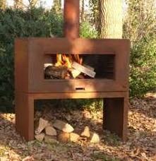 Outdoor antique rusty corten steel metal fireplace with chimney