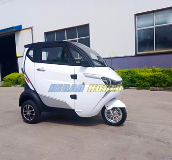 Enclosed electric mobility scooter with seat cover roof