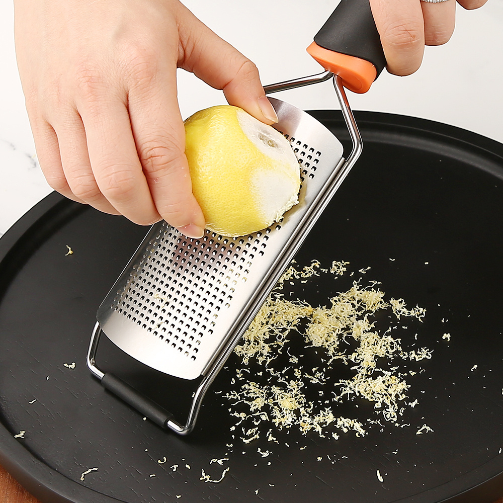 Stainless steel grater for cheese and lemon with plastic handle