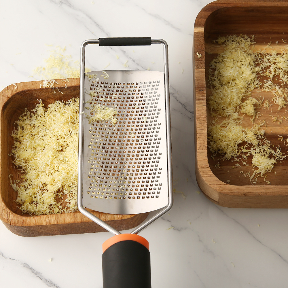 Stainless steel grater for cheese and lemon with plastic handle