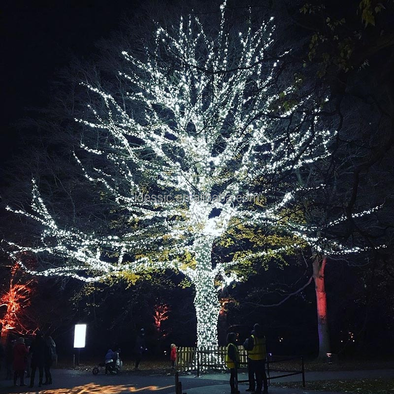 Outdoor connectable tree fairy Christmas lights on tree trunks for winter garden park light show