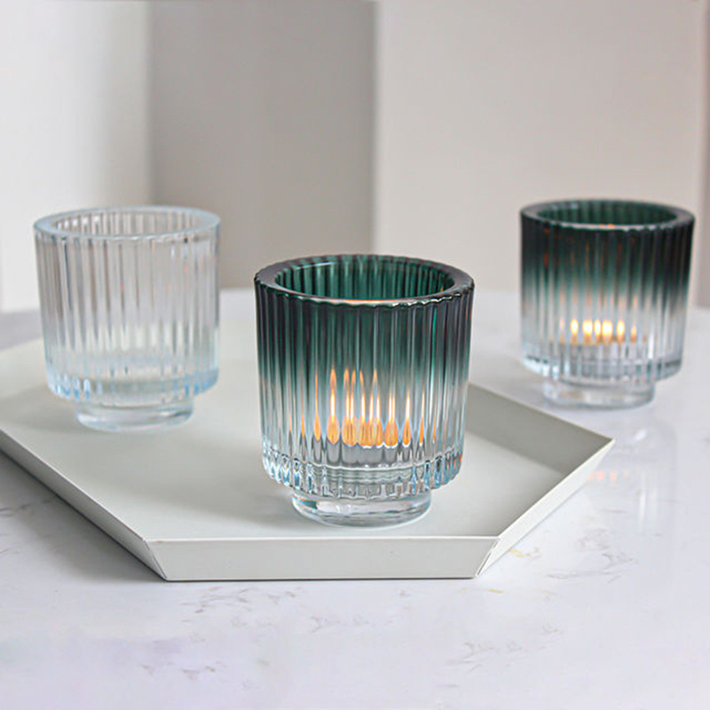 Thick-walled votive glass candle holder with graded color with base stripe