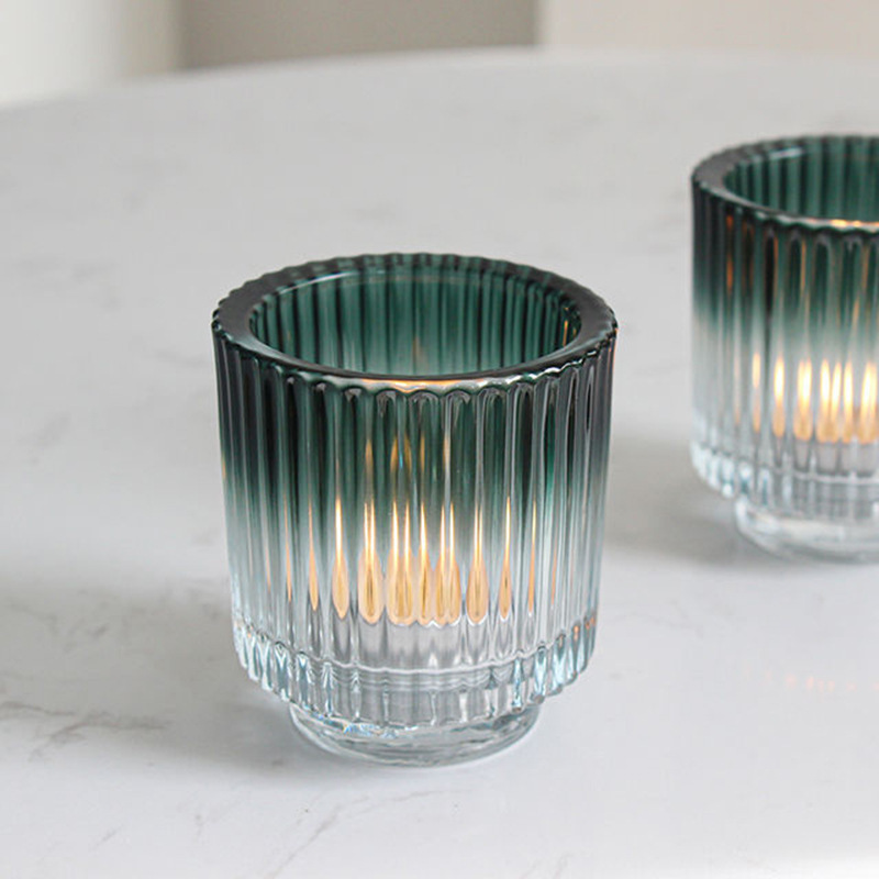 Thick-walled votive glass candle holder with graded color with base stripe