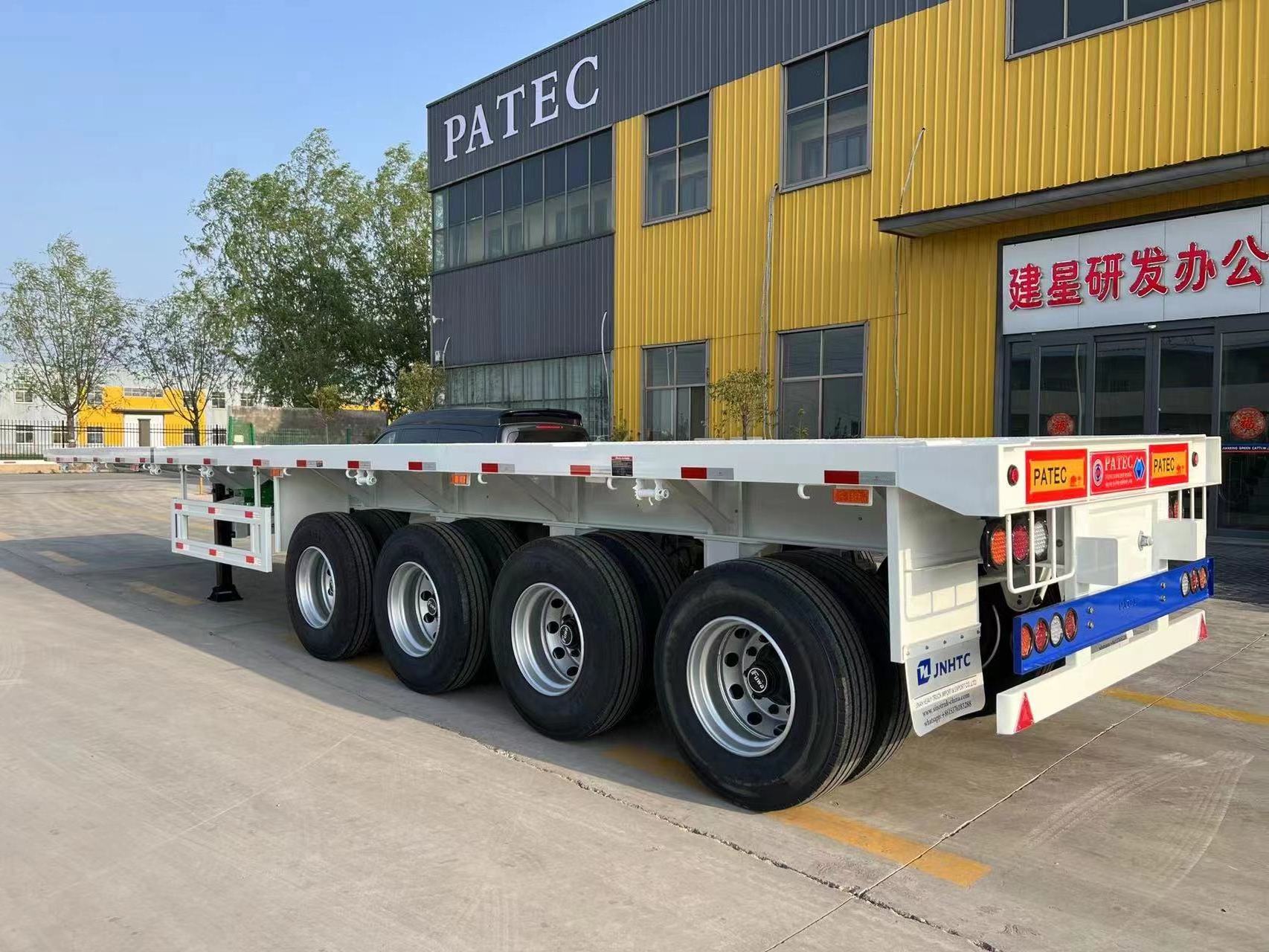 JianXing Factory provide 4 Axles 13m 40ft 60tons 12 twist Locks Flatbed Trailer Flatbed Container Chassi Trailers