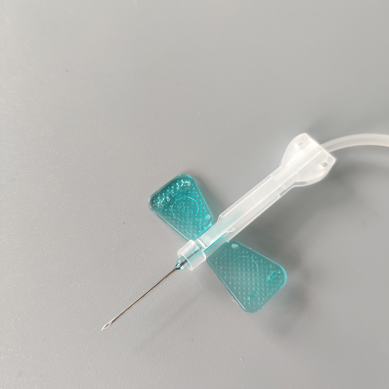 Disposable butterfly blood collection needle with safety device